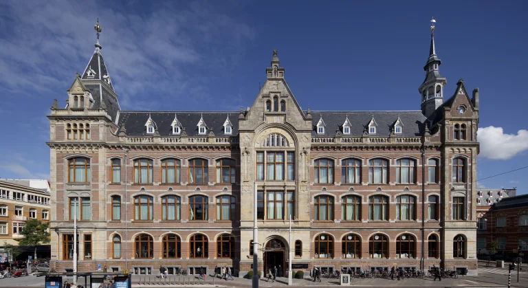 Historisch grachtenpand met rijk versierde gevel in een Nederlandse stad.